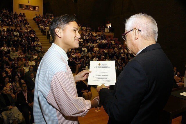 Estudiante recibiendo reconocimiento por parte del Rector General